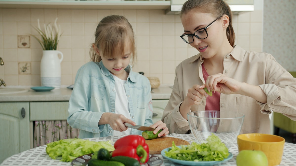 Parents and children mixing ingredients in a bowl together